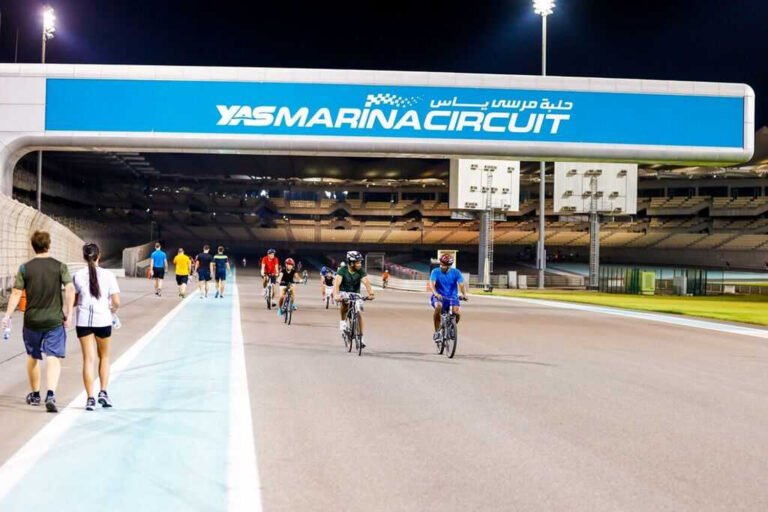 People jogging under the lights at Yas Marina Circuit.